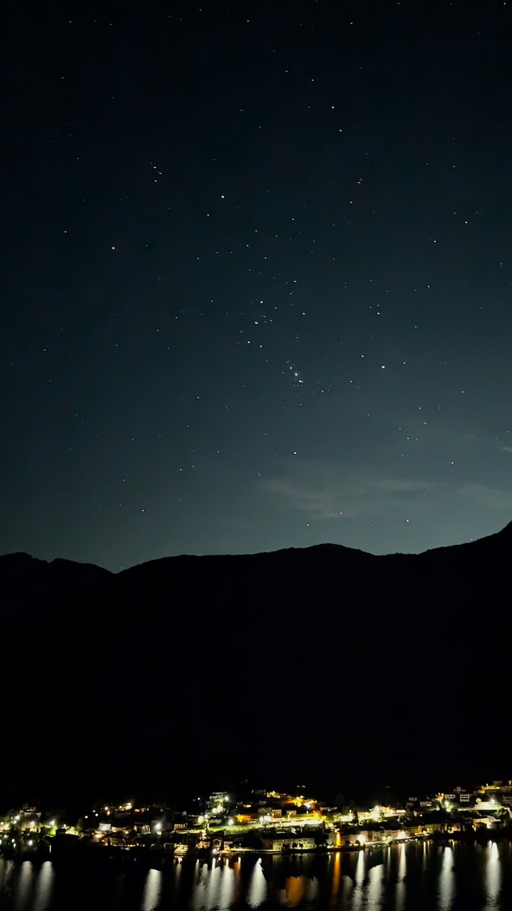 The Orion constellation framed above Lake Lugano at night